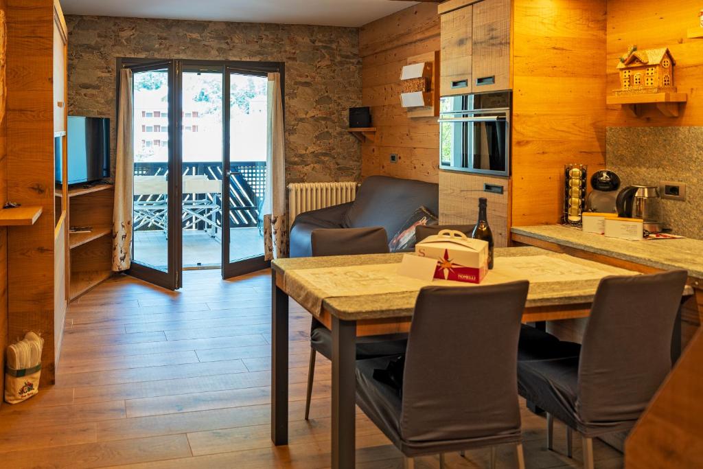 a kitchen with a table and chairs in a room at BERTUZZI HOMES "Luxury Chalet" in Aprica