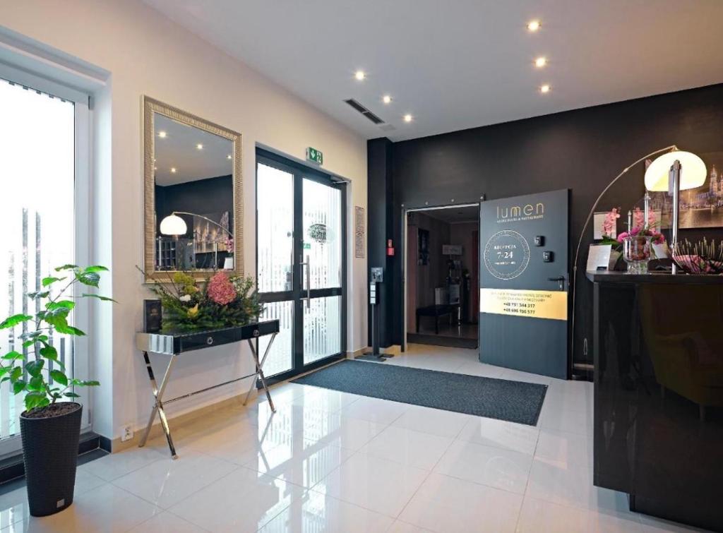 a lobby with a entrance to a store at Lumen in Krakow