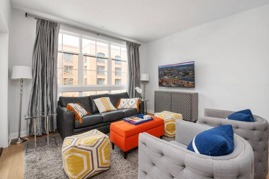 a living room with a couch and a table at Upscale Condo In Annapolis w/Private Parking in Annapolis