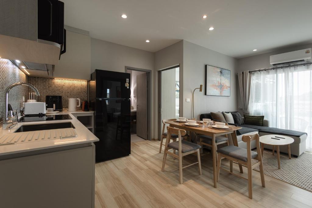 a kitchen and living room with a table and chairs at A417-60m2-2bedroom Serenity 66935B2I976 in Nai Yang Beach