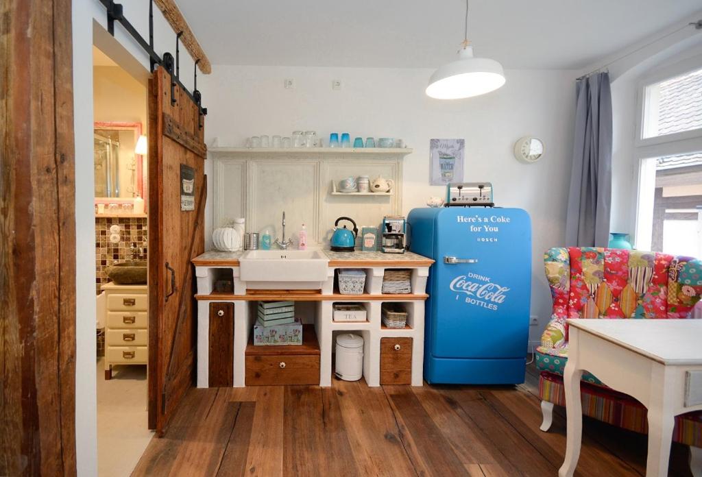 a kitchen with a sink and a blue refrigerator at Schlafstube Bamberg in Bamberg