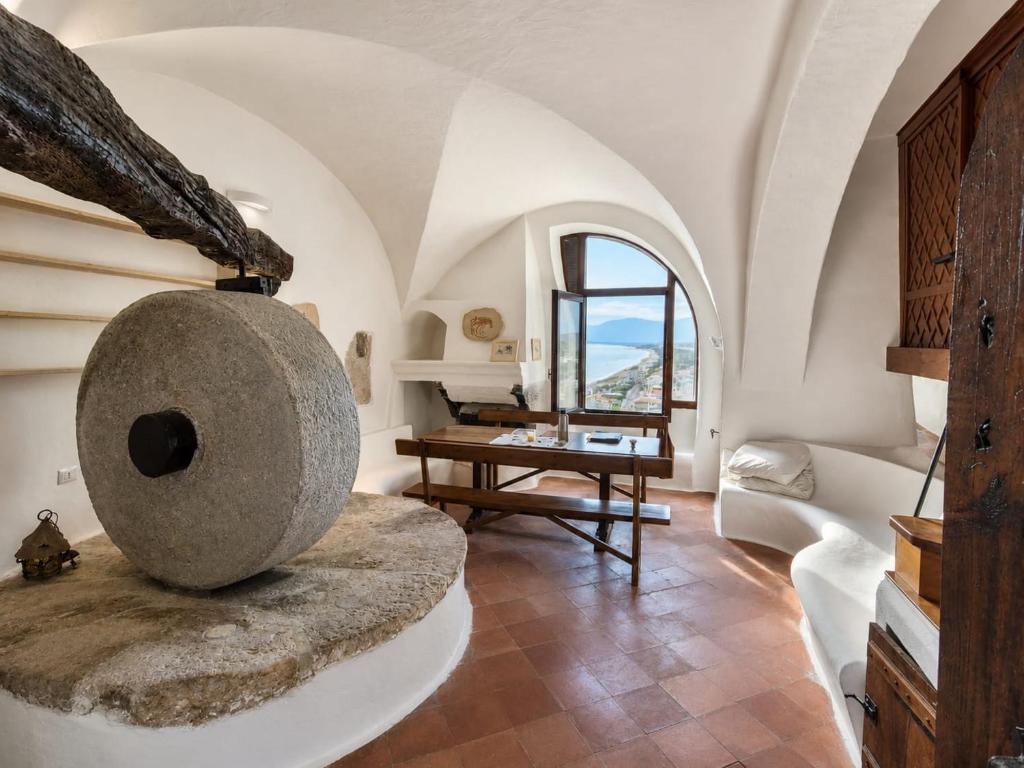 a living room with a couch and a table at Suite Il Mulino - Sea View in Sperlonga