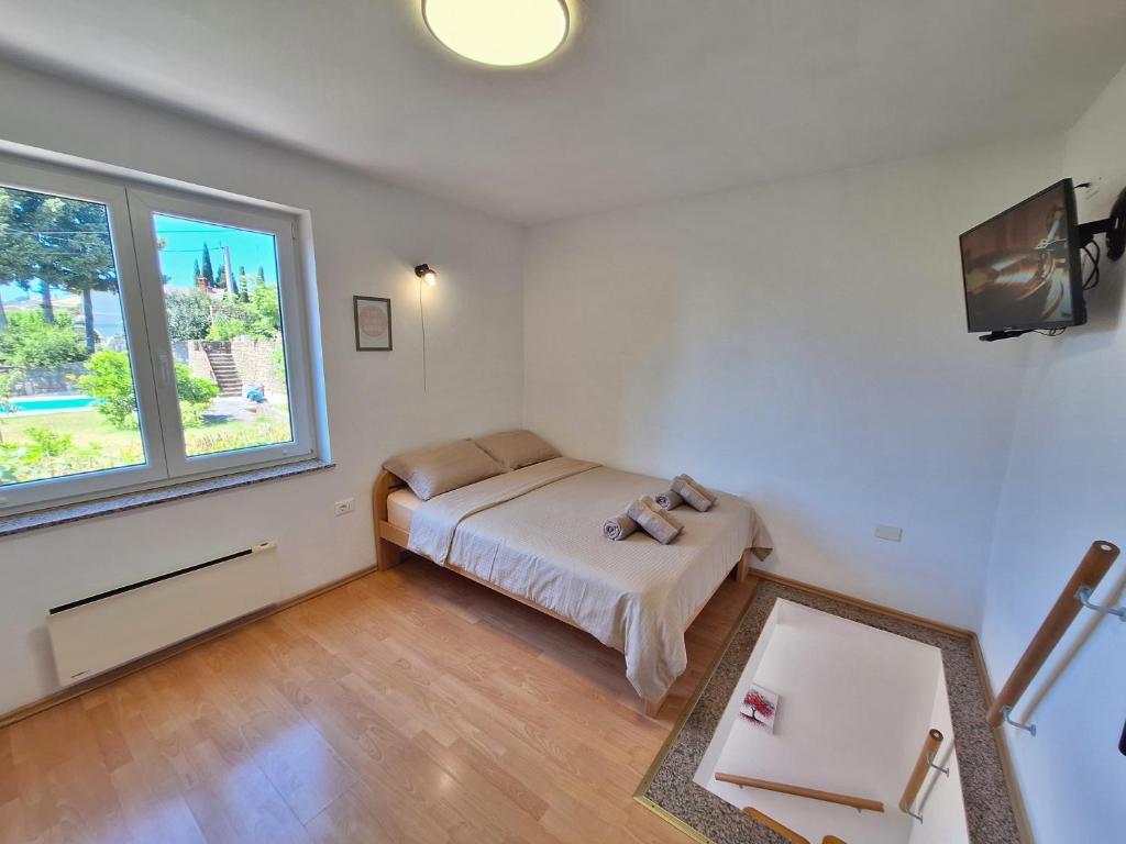 a small bedroom with a bed and a window at Apartment Carolina - Hillside Stay, Steps from the Sea in Portorož