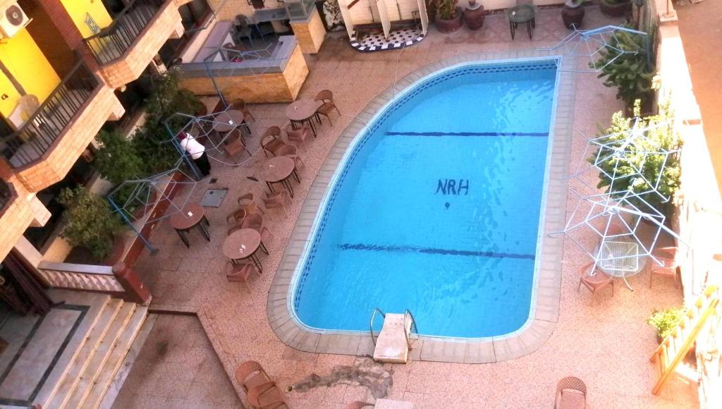 an overhead view of a swimming pool with tables and chairs at New Radwan Hotel, Luxor railways in Luxor
