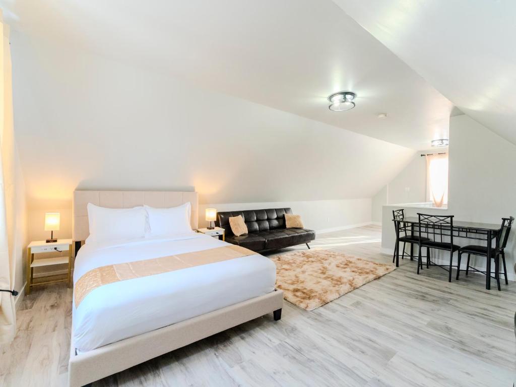 a bedroom with a large bed and a living room at Luvienna Stays in Winnipeg