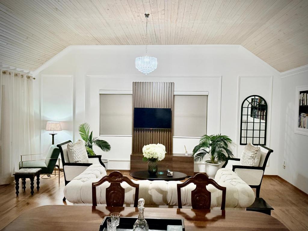 a living room with a couch and a table at Serenity Suite in Somerset West