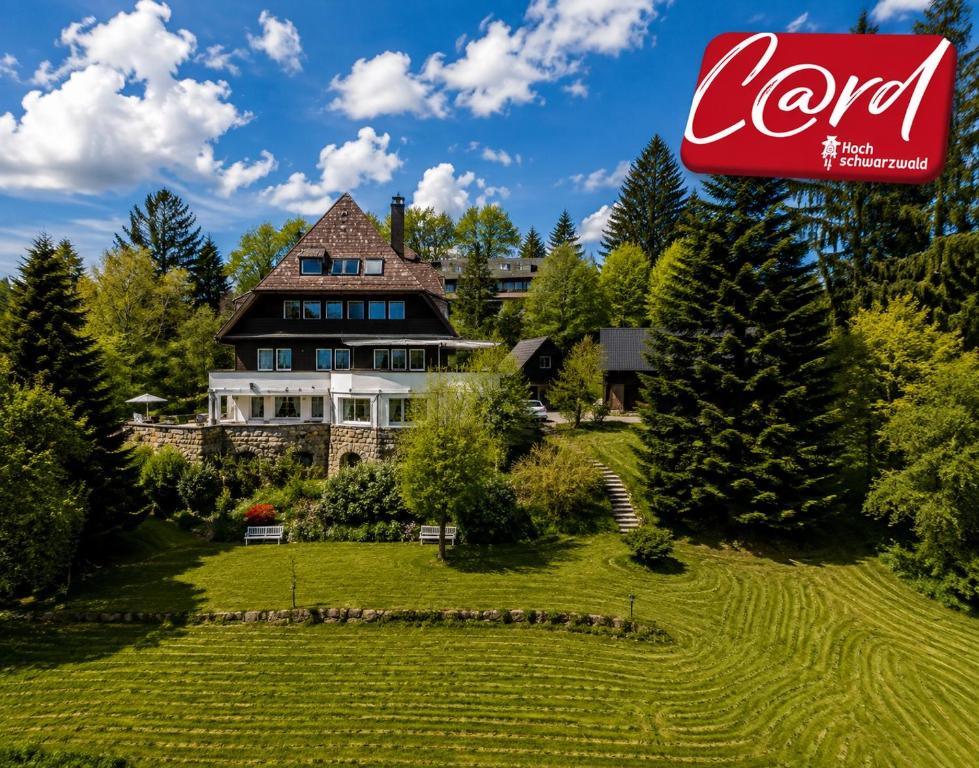 a large house with a sign in front of it at Villa Stradivari - Black Forest with Alpine views in Lenzkirch