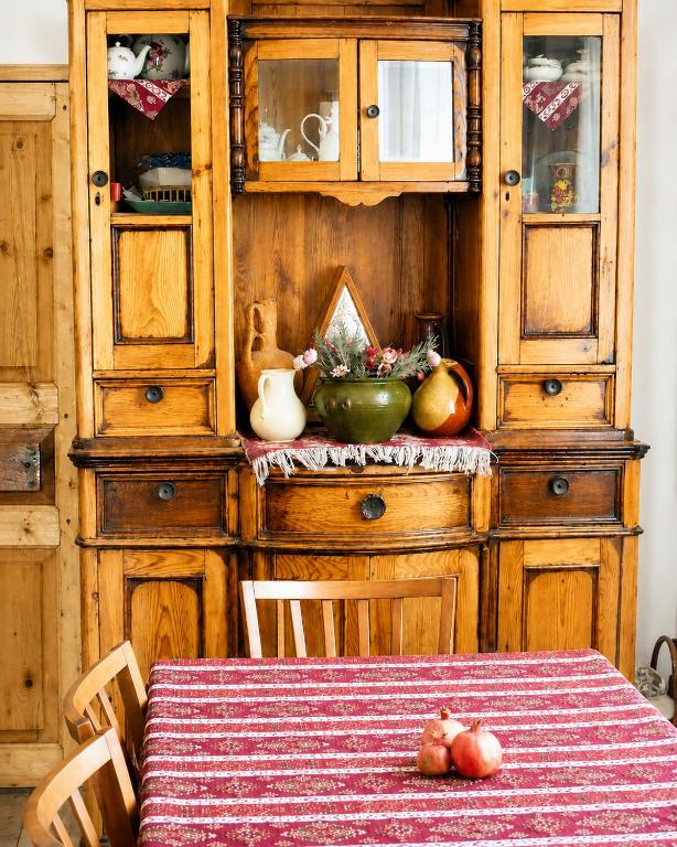 a table with a bowl of fruit on top of a cabinet at Pottery House Sanahin in Alaverdi
