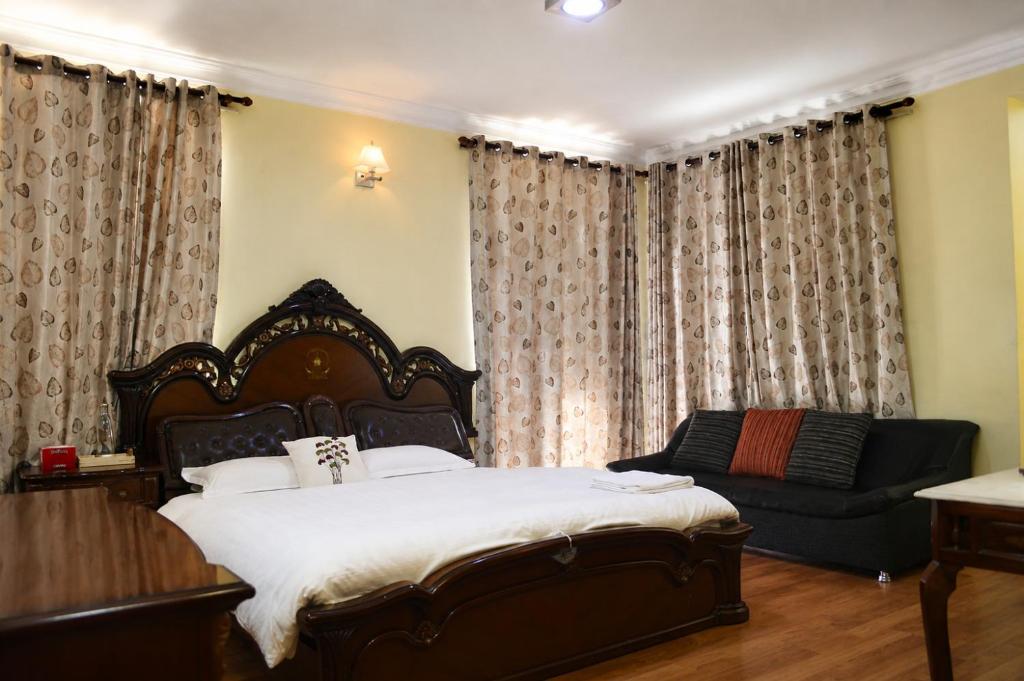 a bedroom with a bed and a couch at Du Nepal Inn in Kathmandu