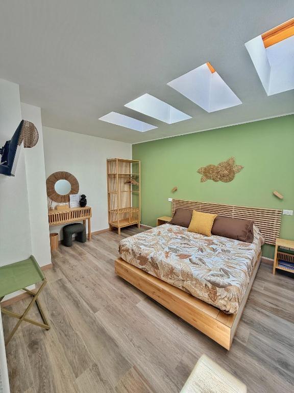 a bedroom with a large bed and a skylight at Amelia Apartment in Maniago