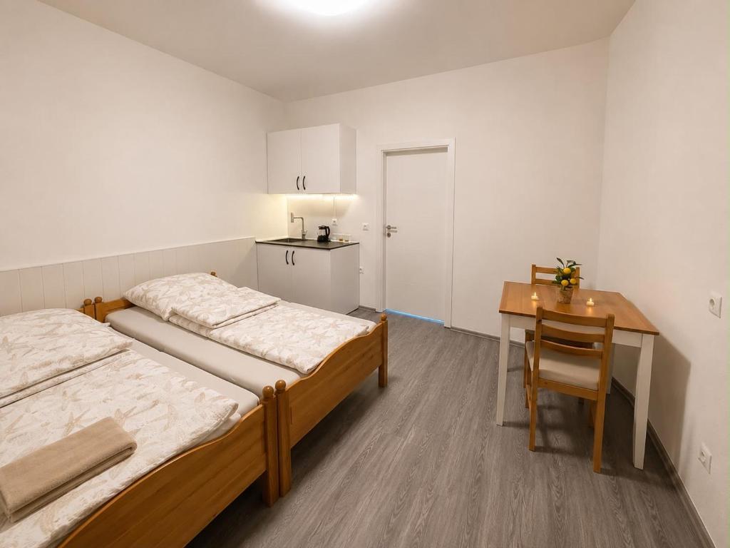 a room with two beds and a desk and a table at Vacation Room in Traben-Trarbach
