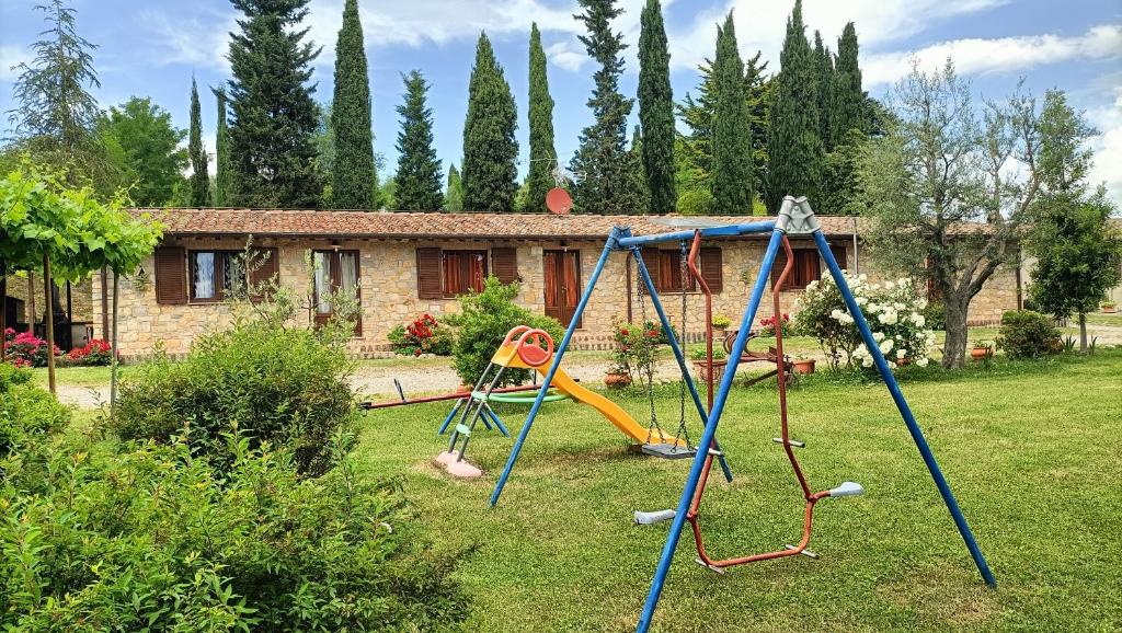 a playground in a yard with a house at Agriturismo Collomici in Celle sul Rigo