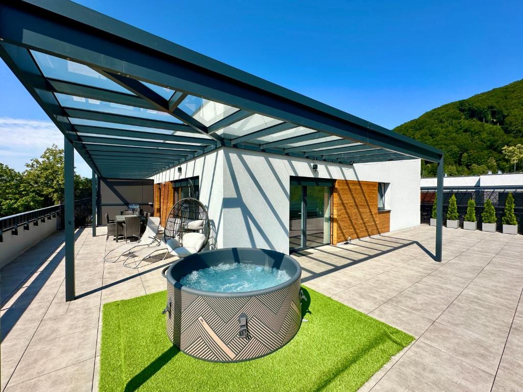 a large hot tub on the deck of a house at Apartmán Raj in Rajecké Teplice