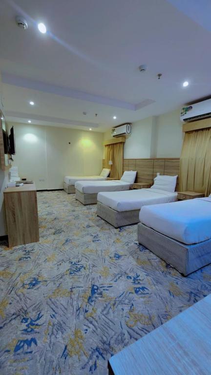 a large room with several beds in it at فندق نسك الفضيلة in Ajyad