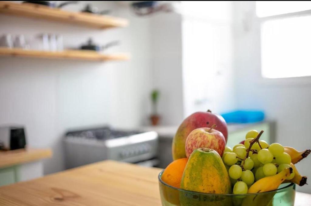 a bowl of fruit on a table in a kitchen at Apartamento T3 Belém in Maputo