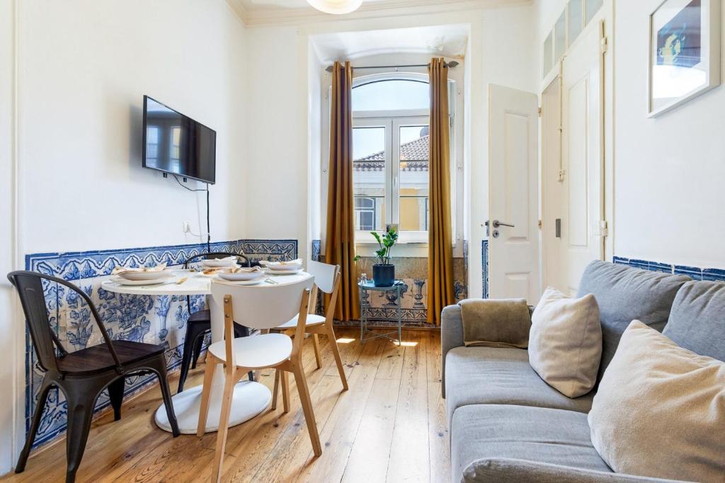 a living room with a couch and a table at Gonzalo's Guest Apartments - Downtown Historic Flats in Lisbon