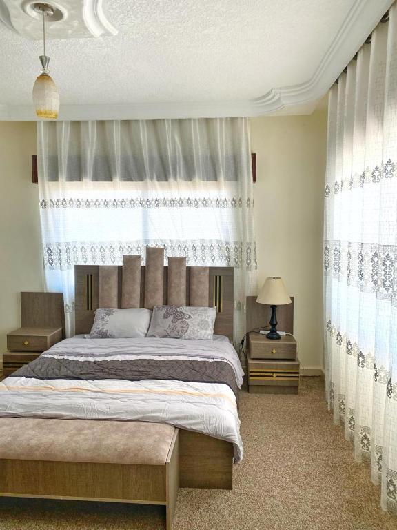 a bedroom with a large bed and a window at بوابة جرش Jarash Gate in Jerash