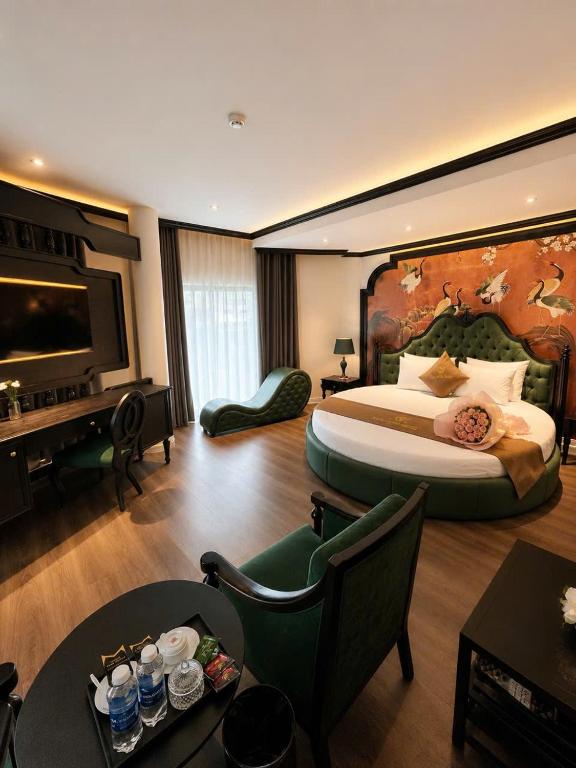 a hotel room with a large bed and a table at Halo hotel & Spa hanoi in Hanoi