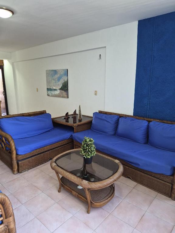 a living room with a blue couch and a table at relax en tucacas in Boca de Aroa