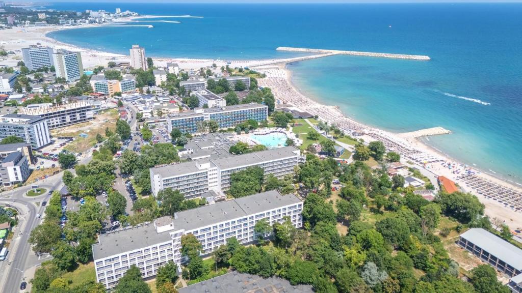 an aerial view of a city and the beach at Hotel Semiramis in Saturn