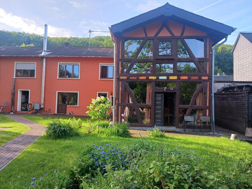 a house with a large gazebo in a yard at Haus Rothenberg - Wohnung Anne in Nohfelden