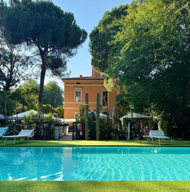 a swimming pool in front of a house at Villa Meraville B&B in Bologna