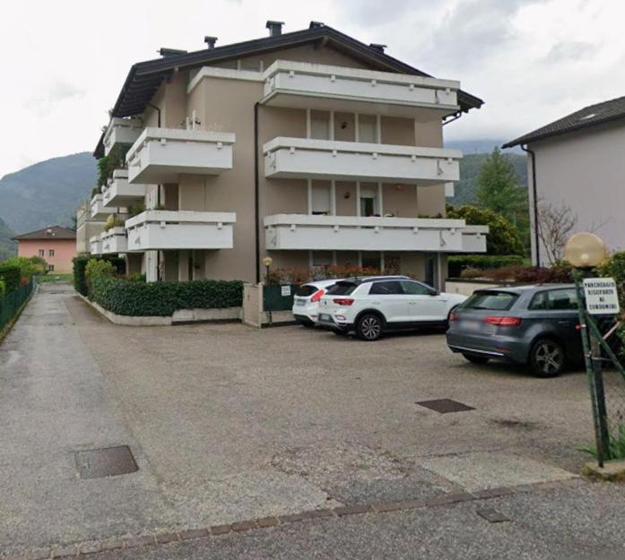 a building with two cars parked in a parking lot at LeRose in Cadine