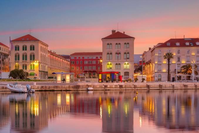 a city with buildings and a river at sunset at Guest House Elizabeta in Split