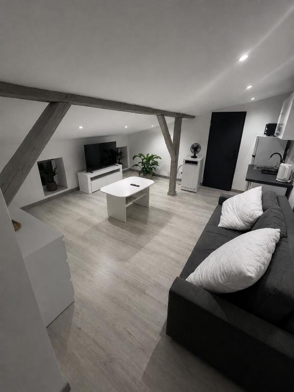 a living room with a couch and a table at Apartament NOVA in Nowa Ruda