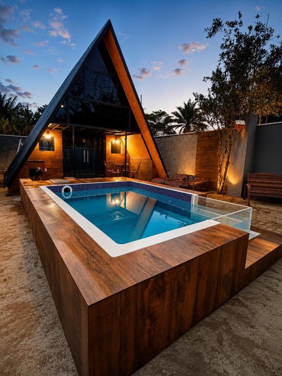 a swimming pool in front of a house at Chalé Boa Vista in Duque de Caxias