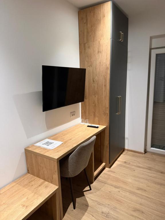 a room with a desk and a tv on a wall at Premium in Negotin