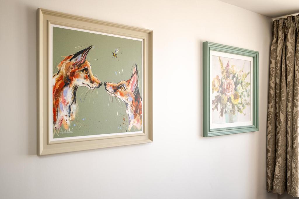 a painting of two dogs on a wall at Central 1BR Flat Full Kitchen & Washing Machine in Andover