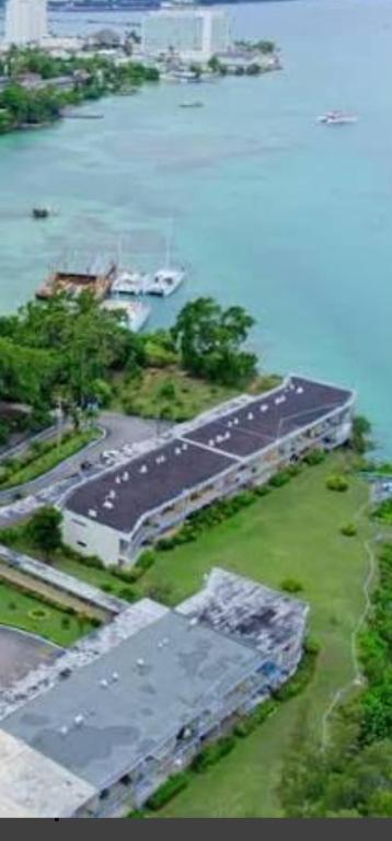 an aerial view of a runway with a boat on the water at Carib Ochi Rios condominium in Ocho Rios