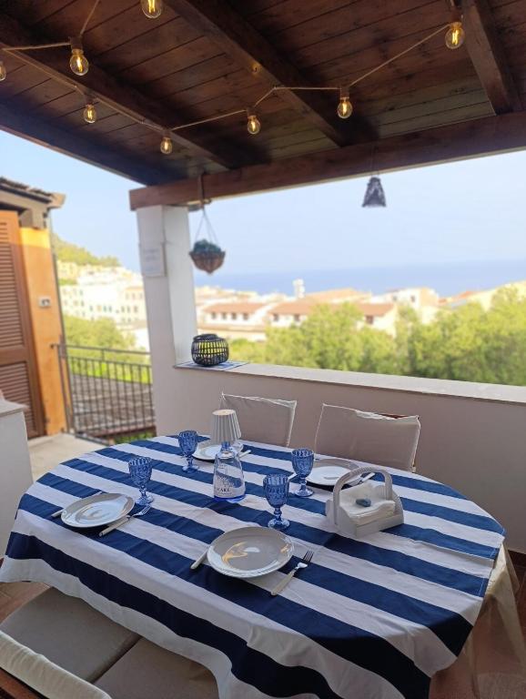 a table with a blue and white striped table cloth at Casa Azzurra con vista Mare in Ustica