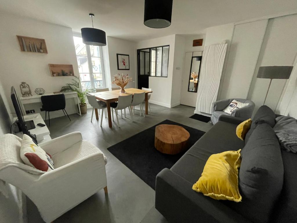 a living room with a couch and a table at Zoralin in Concarneau