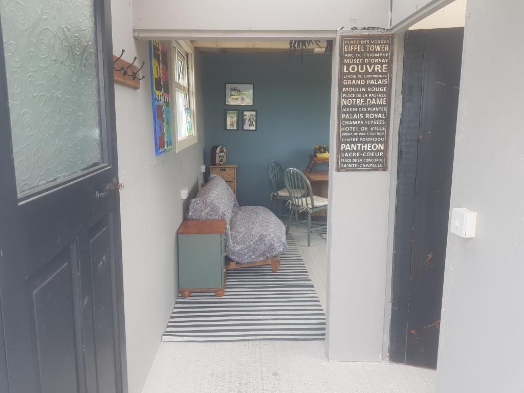 a hallway with a door leading to a dining room at Tiny living on the Wild Atlantic Way in Tralee