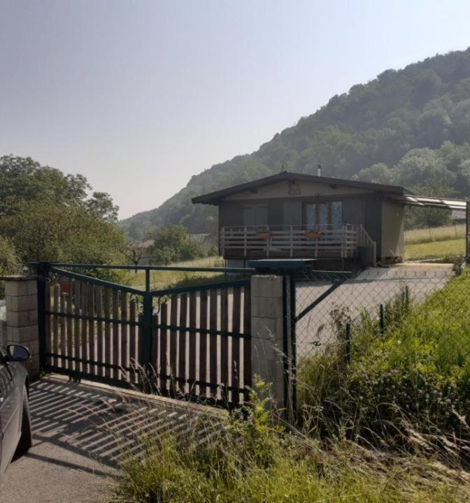 a small house with a gate in front of it at Chalet a la montagne in Cornod