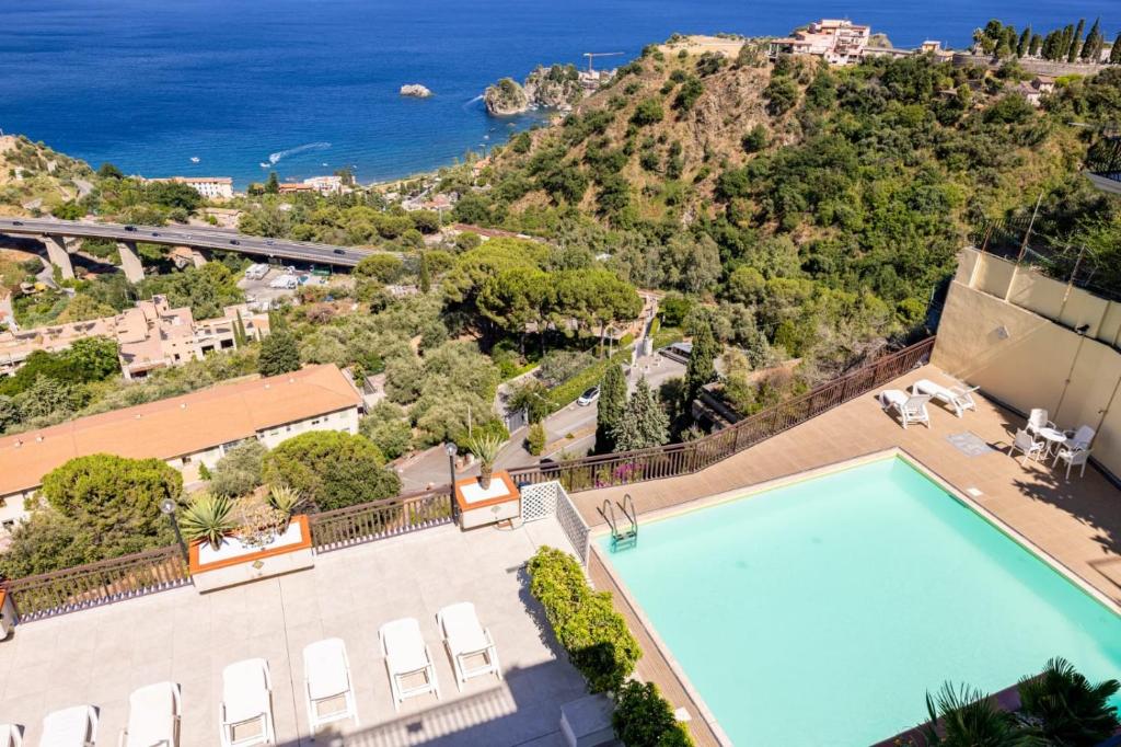 an overhead view of a swimming pool and the ocean at Little Paradise in Taormina