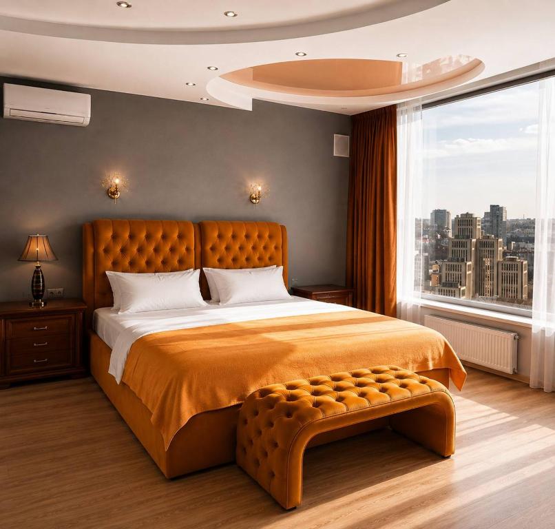 a bedroom with an orange bed with a large window at Seven Eleven Apartment HOTEL in Most City in Dnipro