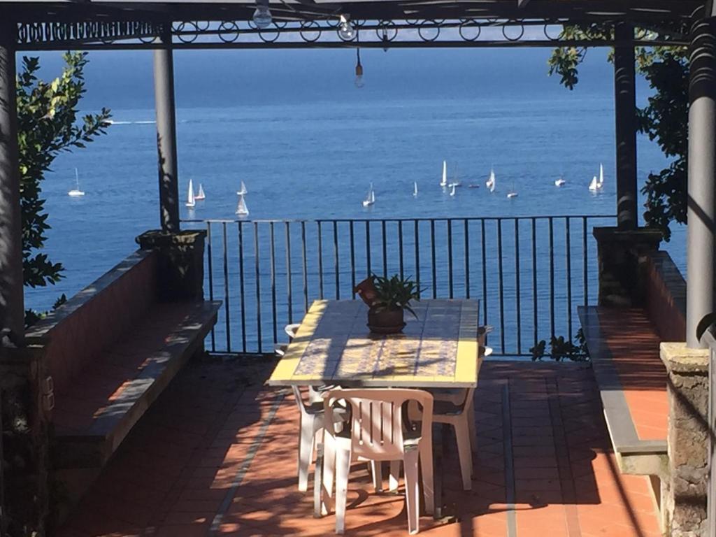 a table and chairs with a view of the ocean at Casa al Belvedere in Vico Equense