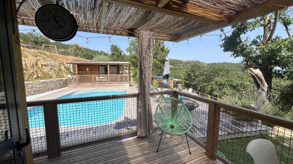 a view from the balcony of a house with a swimming pool at Chalet U Pinu du Jardin de Luiggi in Venaco