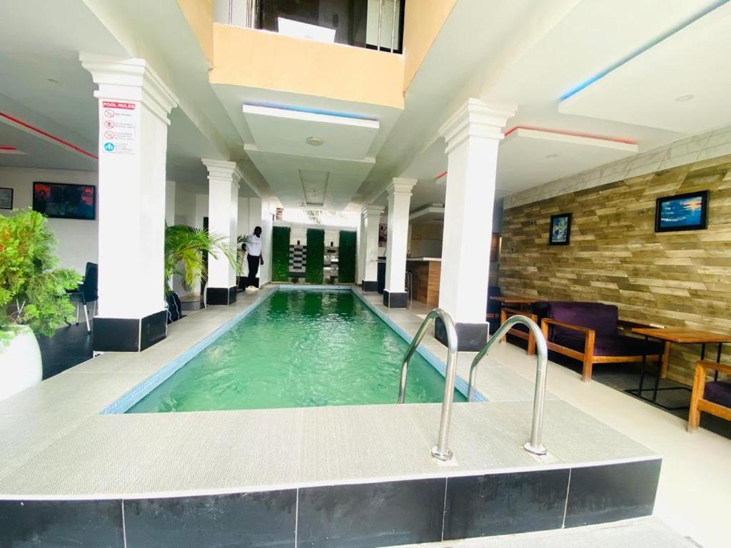 a swimming pool in a hotel lobby at Wiztk suites in Sangotedo
