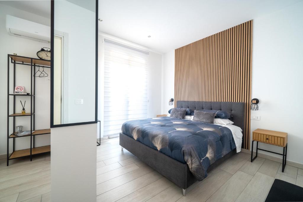 a bedroom with a bed and a large window at Civico 91 Guest House in Silì