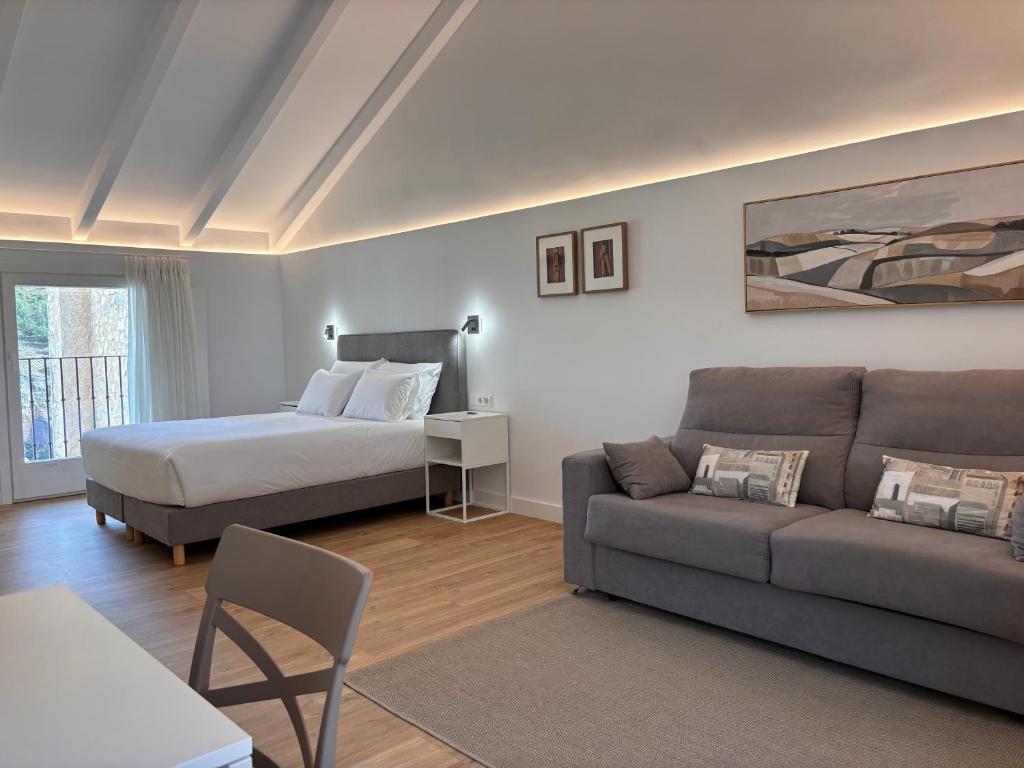a living room with a bed and a couch at Mirador Del Rey in Cuenca