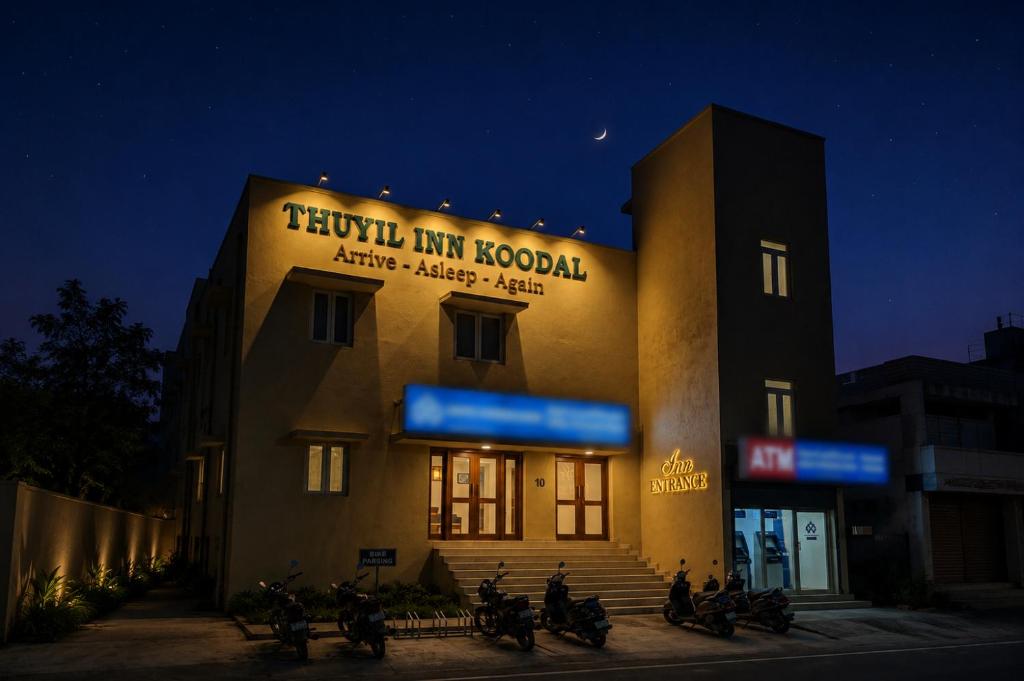 a group of motorcycles parked in front of a building at Thuyil Inn Koodal in Madurai
