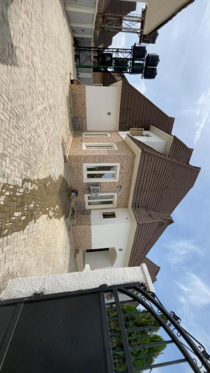 an external view of a building with a roof at The Nest Homes in Abuja