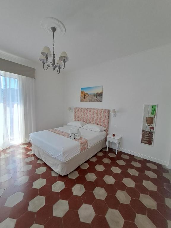 a bedroom with a bed and a checkered floor at Relais Soleil in Vico Equense