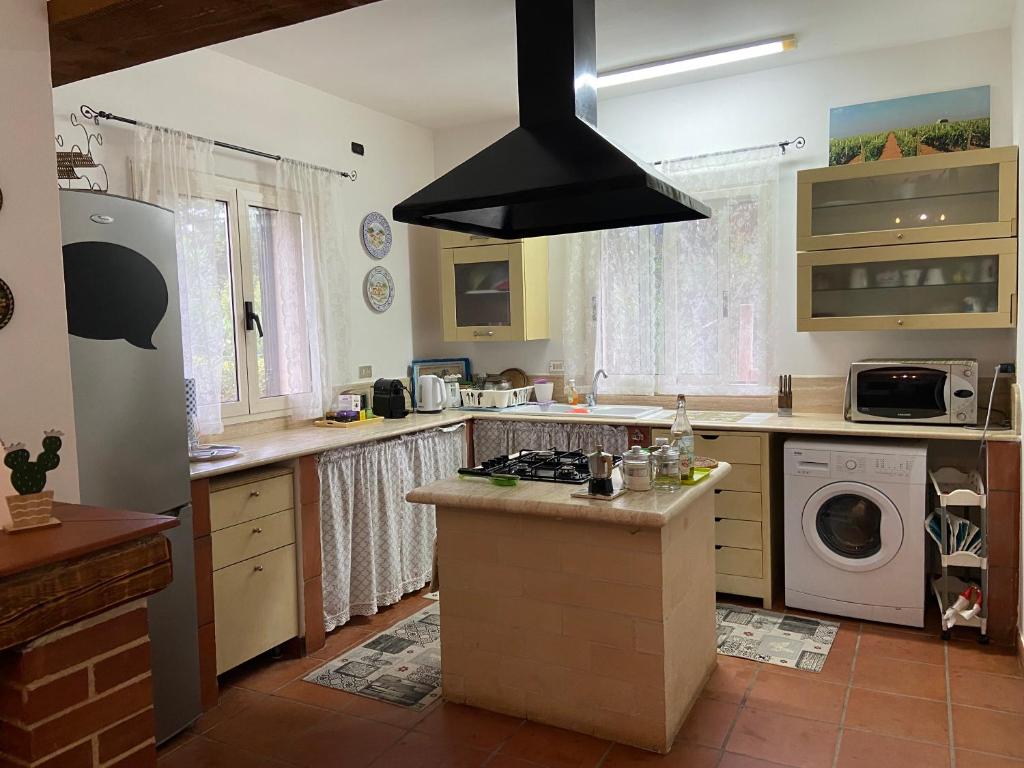 a kitchen with a sink and a stove top oven at Botrus Divin Casa in Brindisi