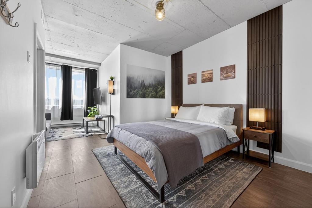 a bedroom with a bed and a tv in it at Lofts Orizon in Rimouski
