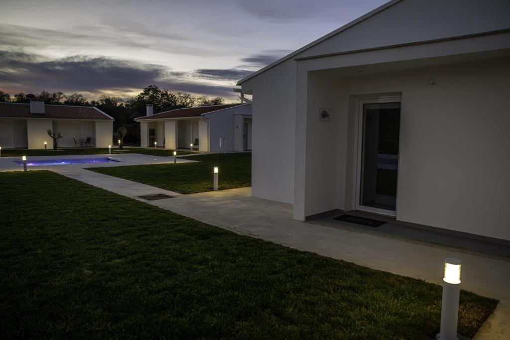 a backyard of a house with lights on the grass at Casa Veigas in Macedo de Cavaleiros